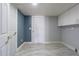 Bright laundry room with painted walls, tile flooring, and white cabinetry, providing ample storage and functionality at 6370 Conniewood Sq, New Port Richey, FL 34653