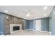 Spacious living room featuring a fireplace and stylish wall accents at 6370 Conniewood Sq, New Port Richey, FL 34653