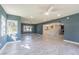 Open-concept living room with tile flooring, a ceiling fan, and access to the kitchen at 6370 Conniewood Sq, New Port Richey, FL 34653