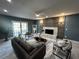 Cozy living room showcasing a fireplace, dark-tone walls, and comfortable seating arrangements at 6370 Conniewood Sq, New Port Richey, FL 34653