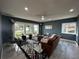 Inviting living room with large windows, tile floors, modern furniture, and plenty of natural light at 6370 Conniewood Sq, New Port Richey, FL 34653