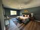 Spacious main bedroom suite with hardwood flooring and a large window showcasing natural light at 6370 Conniewood Sq, New Port Richey, FL 34653