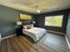 Inviting main bedroom with wood-look floors, ample natural light, and stylish decor at 6370 Conniewood Sq, New Port Richey, FL 34653