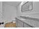 Updated bathroom with granite countertop, modern vanity, and tile flooring at 990 Sunrise Dr, Tarpon Springs, FL 34689