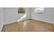 Simple bedroom with hardwood floors and natural light at 990 Sunrise Dr, Tarpon Springs, FL 34689
