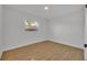Spacious bedroom with hardwood floors and a large window at 990 Sunrise Dr, Tarpon Springs, FL 34689