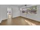 Simple bedroom with hardwood floors and a view of the backyard at 990 Sunrise Dr, Tarpon Springs, FL 34689