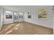 Versatile bonus room with hardwood floors and multiple windows at 990 Sunrise Dr, Tarpon Springs, FL 34689