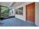 Inviting screened porch entry with updated door and window at 990 Sunrise Dr, Tarpon Springs, FL 34689