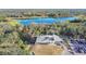An aerial view showcases a clubhouse nestled near a lake and a well-manicured golf course at 5277 Epping Ln, Zephyrhills, FL 33541