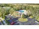 Overhead view showcasing a community center with ample parking and well-kept landscaping near golfing at 5277 Epping Ln, Zephyrhills, FL 33541