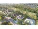 An aerial view of a home and community surrounded by a golf course and green trees at 5277 Epping Ln, Zephyrhills, FL 33541