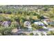 Beautiful aerial view of a charming home, mature trees and landscaping in a well-maintained neighborhood at 5277 Epping Ln, Zephyrhills, FL 33541