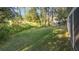 Backyard features a lush lawn with tree lined rear property line at 5277 Epping Ln, Zephyrhills, FL 33541