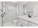 Modern bathroom with a glass-enclosed shower, marble accents, and single sink vanity at 5277 Epping Ln, Zephyrhills, FL 33541