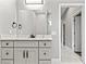 Modern bathroom features a gray vanity with marble countertop and a large mirror at 5277 Epping Ln, Zephyrhills, FL 33541
