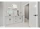 A spacious bathroom with a double sink vanity, marble counters, and an adjacent toilet room at 5277 Epping Ln, Zephyrhills, FL 33541