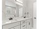 A luxurious bathroom featuring a double sink vanity, marble counters, and a large mirror at 5277 Epping Ln, Zephyrhills, FL 33541