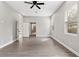 Bedroom showcasing hardwood floors, ceiling fan, and white trim at 5277 Epping Ln, Zephyrhills, FL 33541