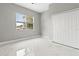 Bedroom featuring white marble floors, closet, and large window at 5277 Epping Ln, Zephyrhills, FL 33541