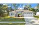 A beautiful one-story house with a two-car garage and landscaped yard at 5277 Epping Ln, Zephyrhills, FL 33541
