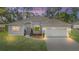 A charming one-story house with a two-car garage and well-manicured lawn at 5277 Epping Ln, Zephyrhills, FL 33541