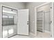 Hallway view of doors to the garage and a closet with shelving at 5277 Epping Ln, Zephyrhills, FL 33541