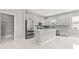 Well-equipped kitchen boasts sleek cabinetry, stainless steel appliances, and a functional center island at 5277 Epping Ln, Zephyrhills, FL 33541