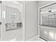 Bright laundry room with sink and cabinets, plus an attached garage with overhead door, both feature tile flooring at 5277 Epping Ln, Zephyrhills, FL 33541