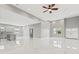 Open concept living room with white marble floors, recessed lighting, and an abundance of natural light at 5277 Epping Ln, Zephyrhills, FL 33541