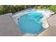 Aerial view of a large community pool with lounge chairs and patio space, perfect for relaxing at 5277 Epping Ln, Zephyrhills, FL 33541