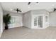 Large screened porch with tile floor and three ceiling fans at 5277 Epping Ln, Zephyrhills, FL 33541