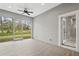 Screened-in porch with tile floor and backyard view at 5277 Epping Ln, Zephyrhills, FL 33541