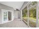 Screened porch featuring wood-look flooring and a view of the backyard at 5277 Epping Ln, Zephyrhills, FL 33541