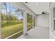 A screened porch offers backyard views and outdoor living at 5277 Epping Ln, Zephyrhills, FL 33541