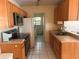 Cozy kitchen featuring wood cabinets and modern appliances at 6022 Flora Ter, Apollo Beach, FL 33572