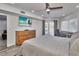 Main bedroom with a large dresser, work desk, and access to balcony at 18400 Gulf Blvd # 1206, Indian Shores, FL 33785