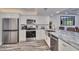Modern kitchen with stainless steel appliances and farmhouse sink at 18400 Gulf Blvd # 1206, Indian Shores, FL 33785