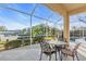 Screened patio with table and chairs, overlooking the pool and canal at 3832 5Th Ne Ave, Bradenton, FL 34208