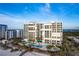 Aerial view of beachfront building with pool and beach access at 1800 Benjamin Franklin Dr # B809, Sarasota, FL 34236