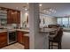 Modern kitchen bar with granite countertop and view to living room at 1800 Benjamin Franklin Dr # B809, Sarasota, FL 34236