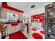 Kitchen with red accents and white cabinets at 6153 9Th Ave, New Port Richey, FL 34653