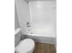 Clean bathroom with a shower/tub combo and wood-look floors at 6844 Northlake Dr, Zephyrhills, FL 33542