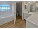 Main bathroom with a tub, toilet, and double vanity at 6844 Northlake Dr, Zephyrhills, FL 33542