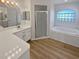 Bathroom with a garden tub, shower, and double vanity at 6844 Northlake Dr, Zephyrhills, FL 33542