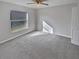 Bright bedroom with plush carpet and large window at 6844 Northlake Dr, Zephyrhills, FL 33542