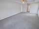 Spacious main bedroom with plush carpeting and ceiling fan at 6844 Northlake Dr, Zephyrhills, FL 33542