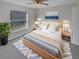 Main bedroom with a king-size bed, large window and ceiling fan at 6844 Northlake Dr, Zephyrhills, FL 33542