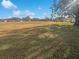 View of homes and open green space in a residential community at 6844 Northlake Dr, Zephyrhills, FL 33542