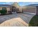 Brick house with a two-car garage and a screened entryway at 6844 Northlake Dr, Zephyrhills, FL 33542